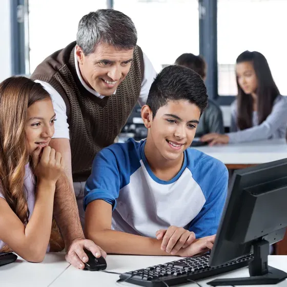 A teacher and students at a computer